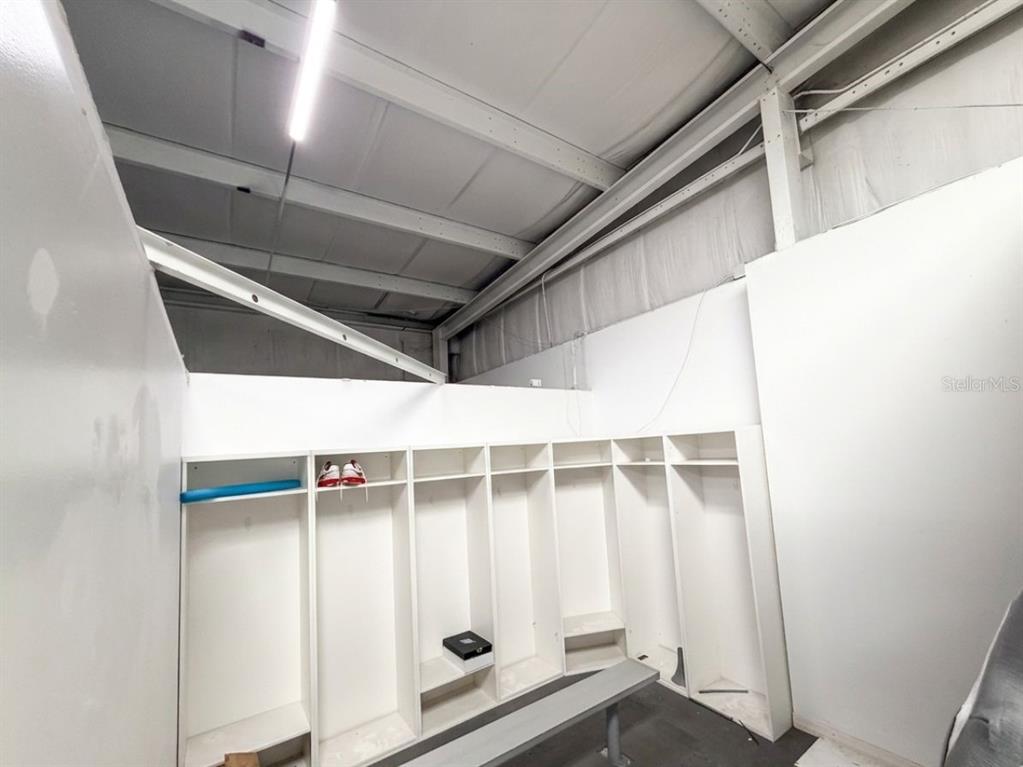 A large indoor sports facility features a lounge area with a sofa and basketball court — 2013 MURCOTT DRIVE UNIT 1,2,3, ST CLOUD, FL