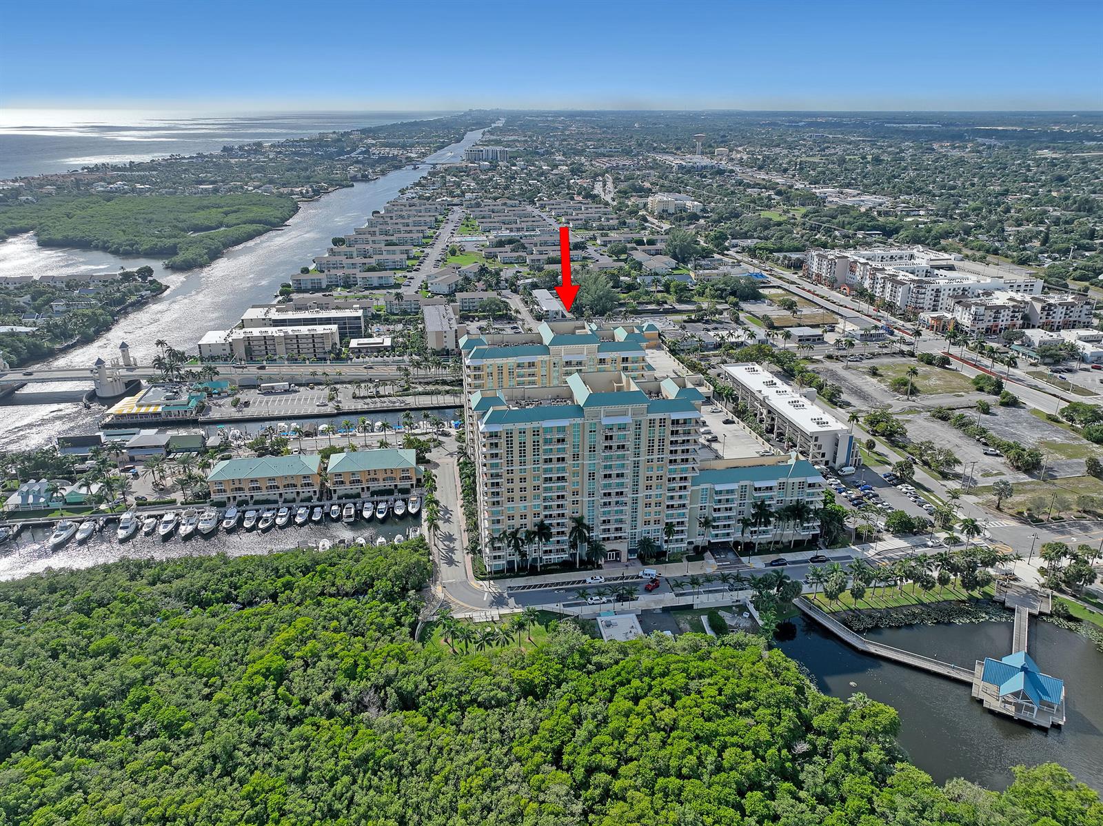 An aerial view shows a large multi-story apartment complex surrounded by trees and water — 700 E Boynton Beach Boulevard # 312, Boynton Beach FL 33435, BOYNTON BEACH, FL