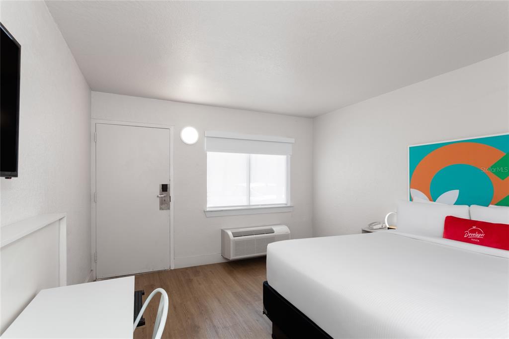 A hotel room features a bed, a desk, a window, and a door — 5367 W IRLO BRONSON MEMORIAL HIGHWAY UNIT 2-214, KISSIMMEE, FL