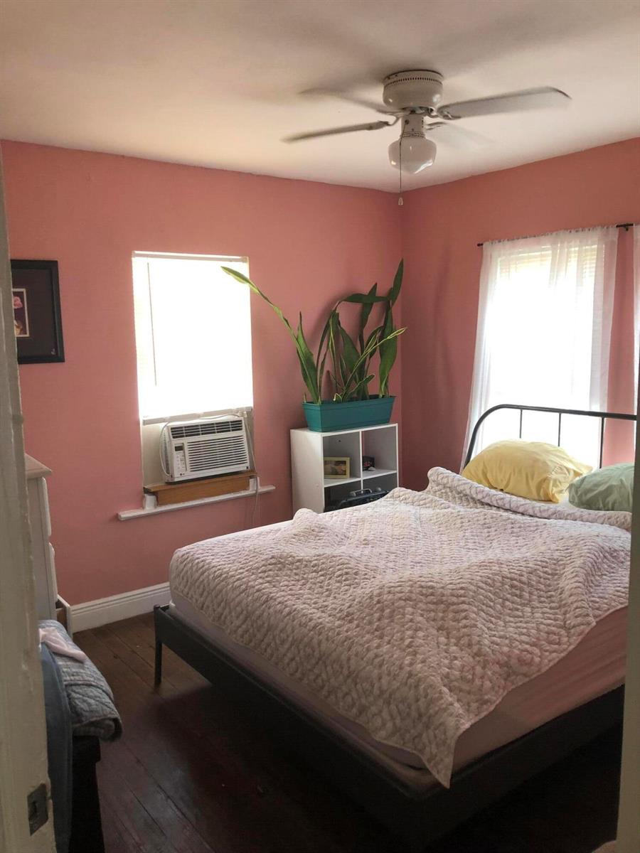A bedroom with pink walls, a ceiling fan, a bed, and a window air conditioner — 1021 SW 5th Street, Miami FL 33130, MIAMI, FL
