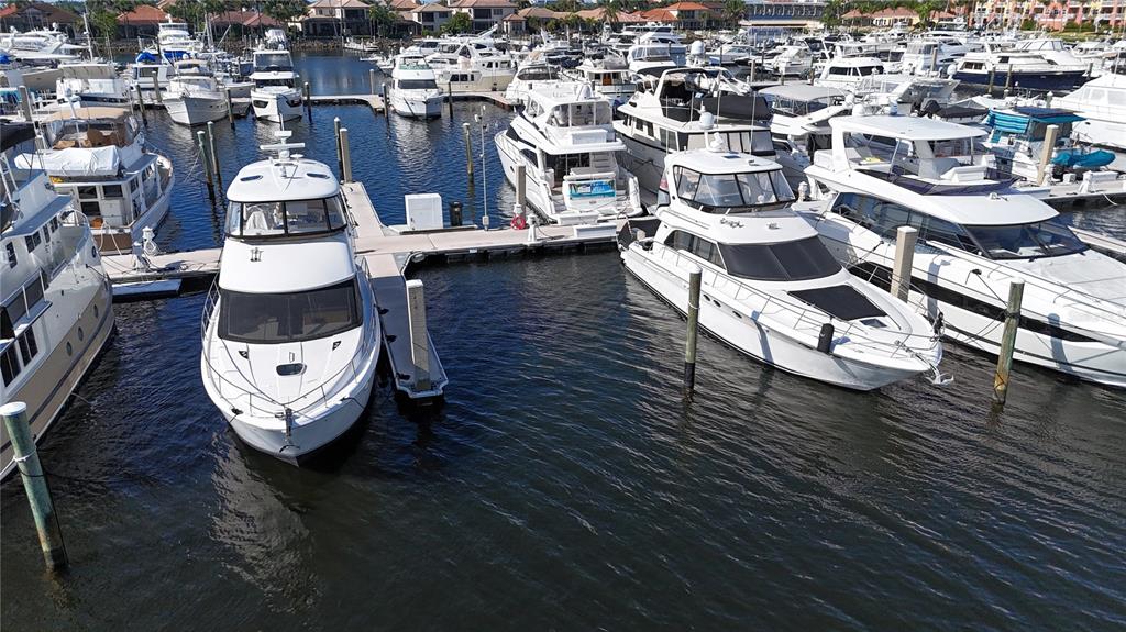 An aerial view shows several white yachts docked at a marina on a sunny day — 102 RIVIERA DUNES WAY UNIT C-24, PALMETTO, FL