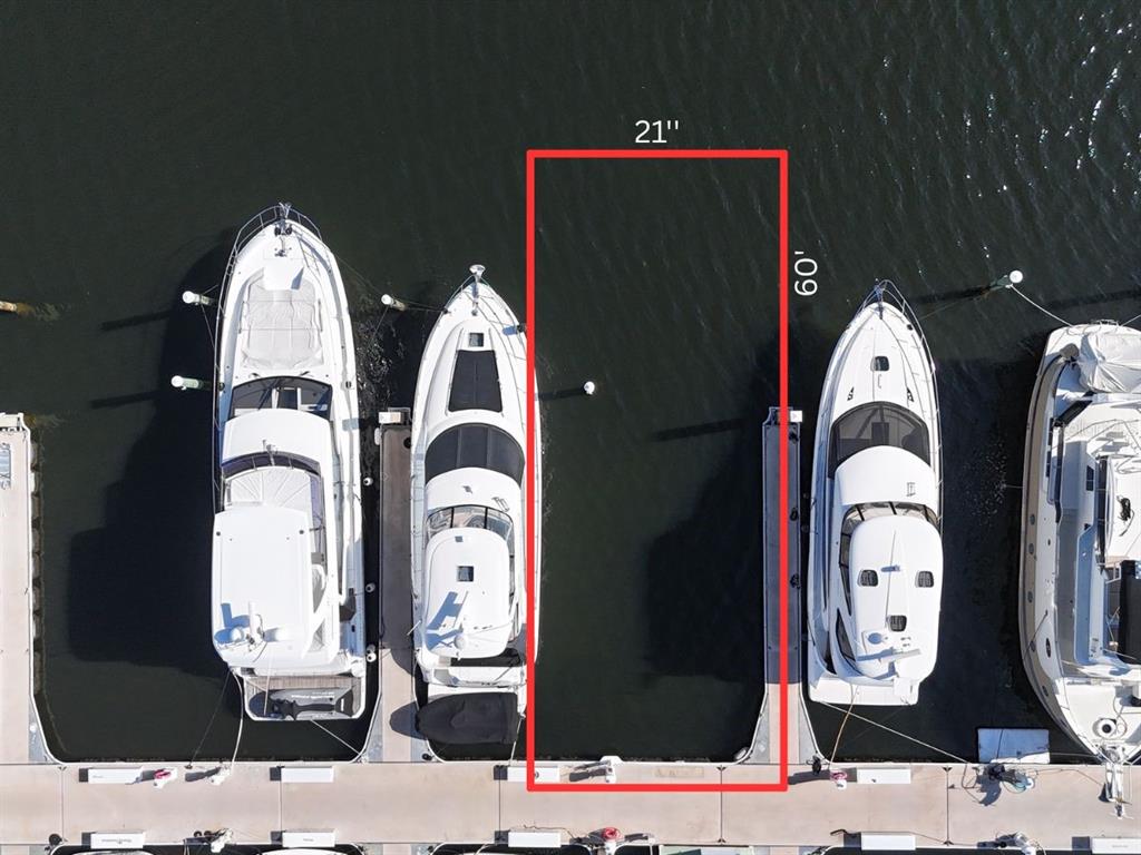 This aerial view shows a rectangular boat slip measuring 21 feet by 60 feet — 102 RIVIERA DUNES WAY UNIT C-24, PALMETTO, FL