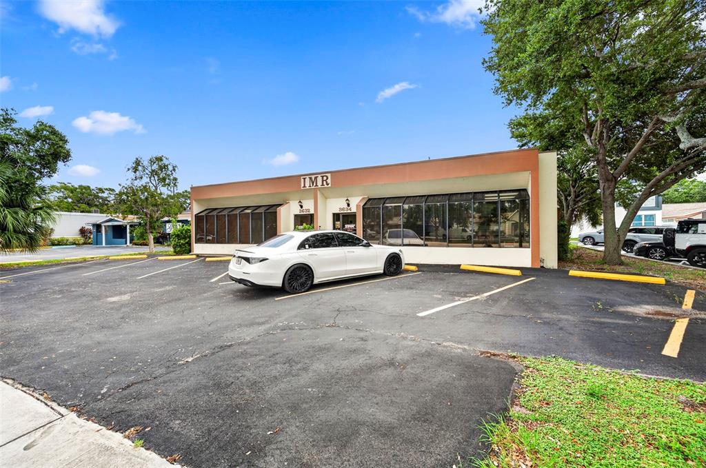 A white sedan is parked in front of a single-story commercial building with large windows — 3632 CENTRAL AVENUE, ST PETERSBURG, FL