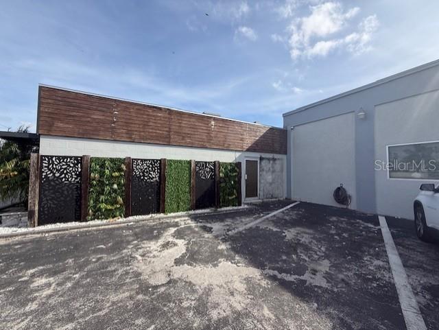 Exterior view of a building with a wood-paneled facade and decorative metal privacy screens — 3852 L B MCLEOD ROAD, ORLANDO, FL