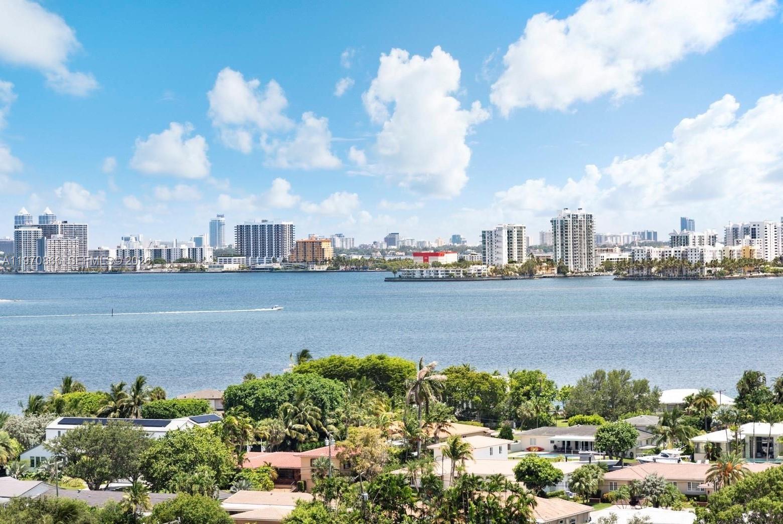 A wide-angle view of a waterfront residential area with a city skyline in the distance — 2000 Towerside Ter # 1408, Miami FL 33138, MIAMI, FL