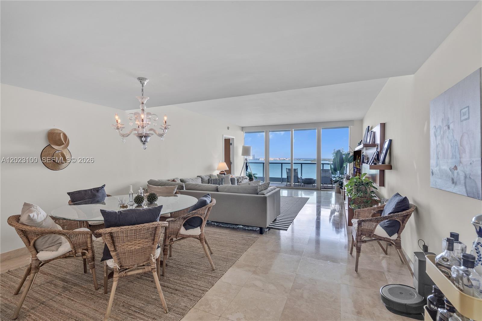 A bright living and dining area features tile floors, a glass table, and balcony views — 1331 Brickell Bay Dr # 2007, Miami FL 33131, MIAMI, FL