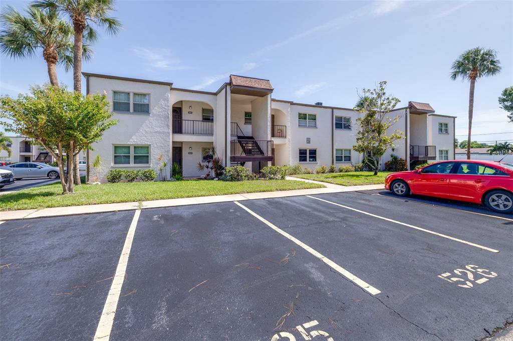 A two-story apartment building exterior with a parking lot in the foreground — 7701 STARKEY ROAD UNIT 528, SEMINOLE, FL