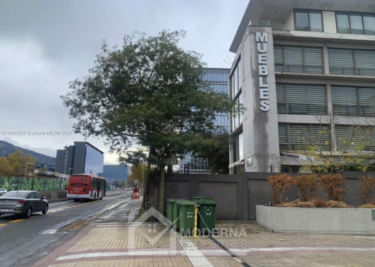 A street-level view shows a building with a Muebles sign, a bus, and green trash bins — Avda. Las Condes 10.527, 8320269, FL