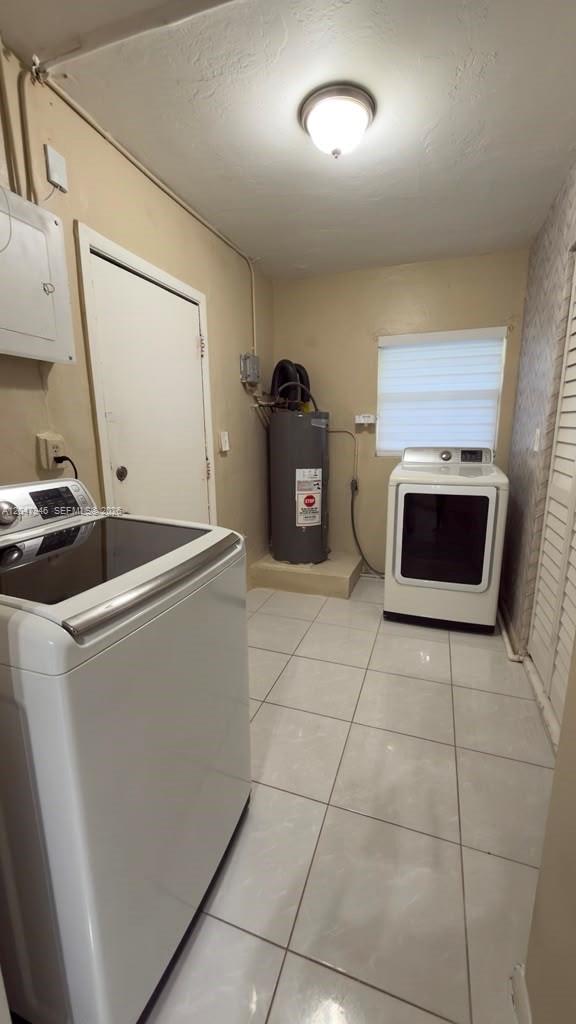 A bright room features white tiled floors, a large window with blinds, and wood-slat wall paneling — 19200 NW 44th Ave, Miami Gardens FL 33055, MIAMI GARDENS, FL