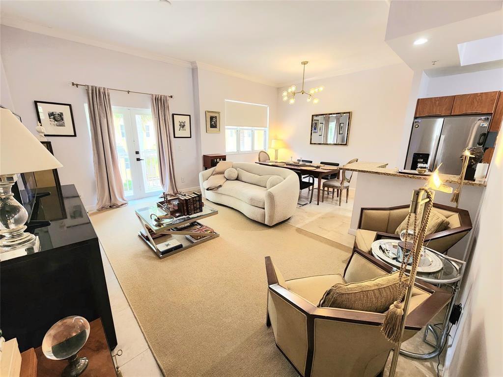 A living room with a beige sofa, two armchairs, a dining area, and a kitchen — 2317 Vintage Drive, Lighthouse Point FL 33064, LIGHTHOUSE POINT, FL