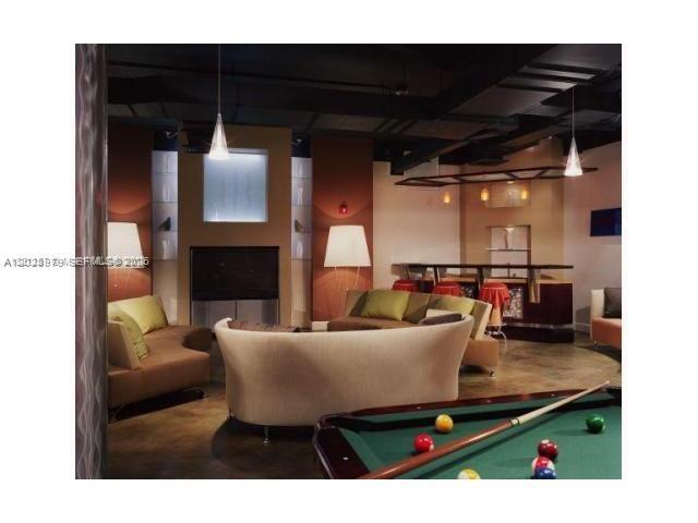 A lounge area features a pool table, curved sofa, seating, and a bar — 10 SW South River Dr # 801, Miami FL 33130, MIAMI, FL