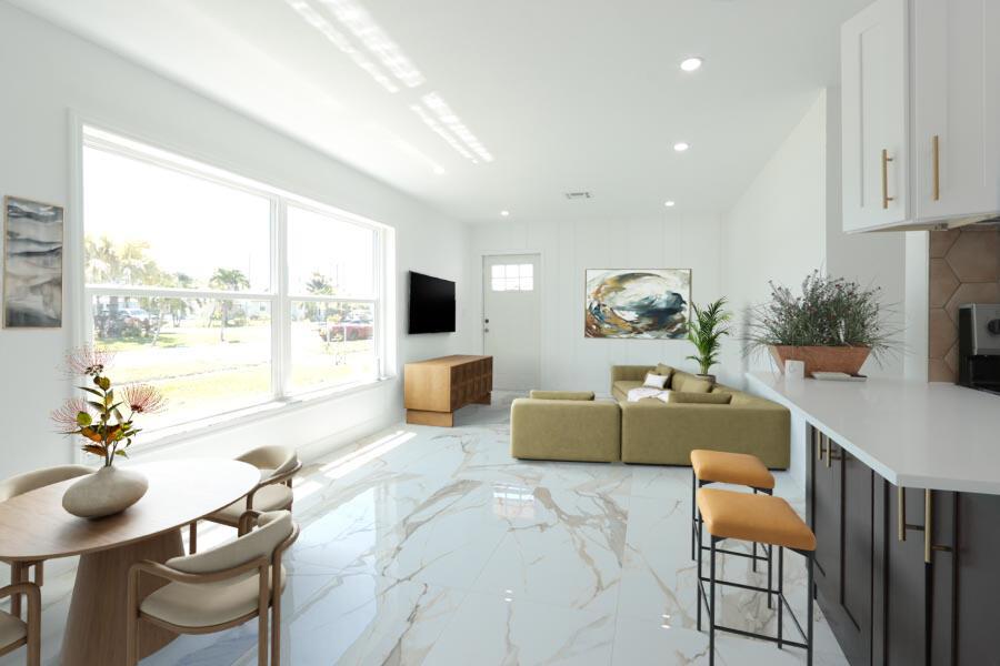 This rendering shows an open-concept living and dining area with marble-look tile flooring — 251 Avenue O, Riviera Beach FL 33404, RIVIERA BEACH, FL