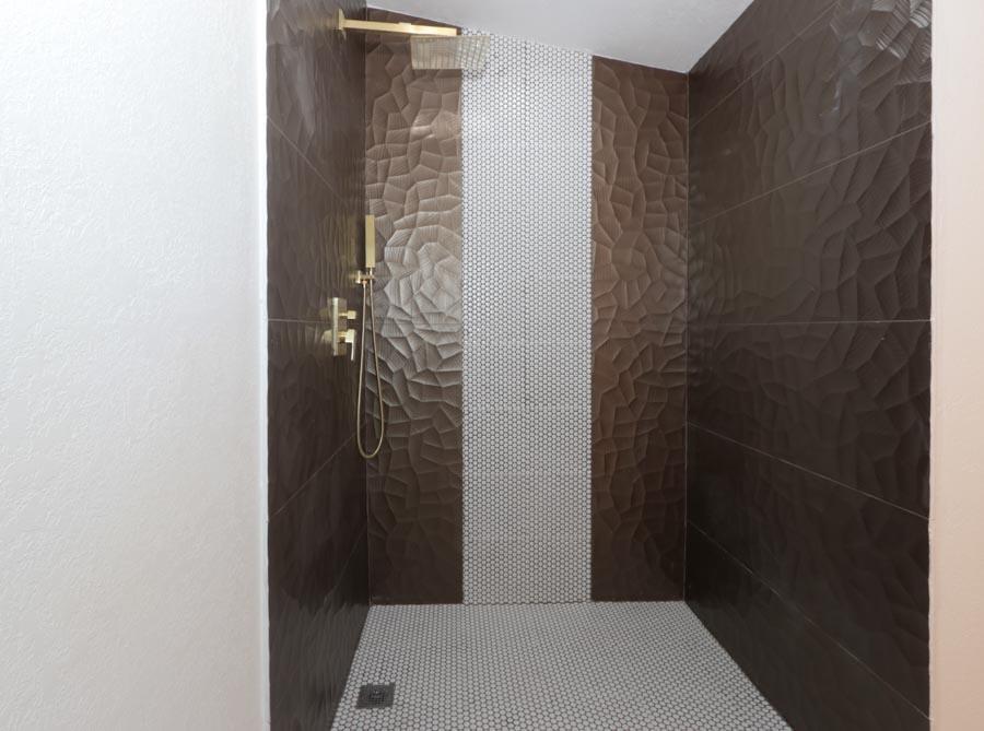 A walk-in shower features dark textured wall tiles, a white penny tile accent, and gold fixtures — 251 Avenue O, Riviera Beach FL 33404, RIVIERA BEACH, FL
