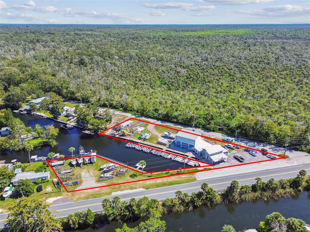 An aerial view shows a boat storage facility with a marina and parking lot — 7154 SHOAL LINE BOULEVARD, WEEKI WACHEE, FL