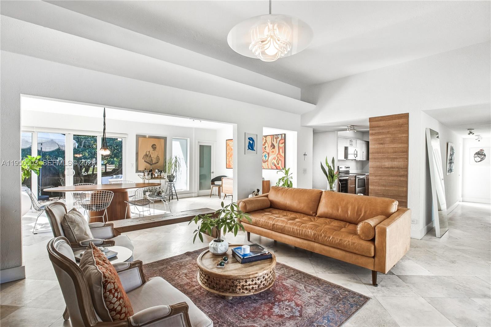 A living room features a leather sofa, two armchairs, a round coffee table, and tile flooring — 1106 NE 86th St, Miami FL 33138, MIAMI, FL
