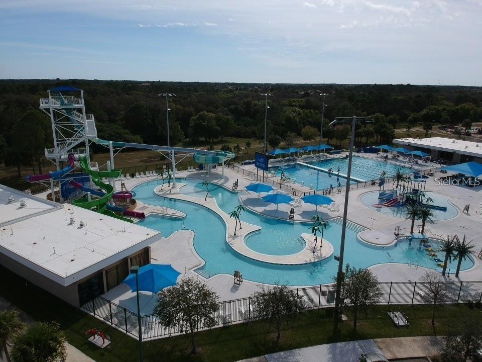 An aerial view of a community swimming pool complex featuring water slides and lounge areas — 17460 IAGO AVENUE, PORT CHARLOTTE, FL