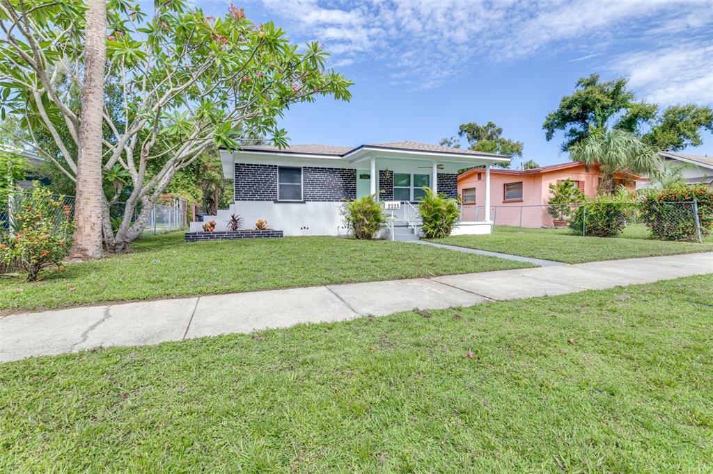 A single-story house with a black brick facade, white trim, and a front porch — 2325 HIGHLAND STREET S, ST PETERSBURG, FL
