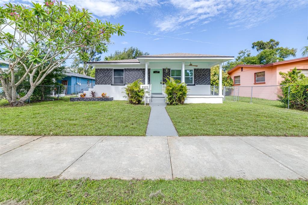 A single-story house with a black brick facade, a light green door, and a front porch — 2325 HIGHLAND STREET S, ST PETERSBURG, FL