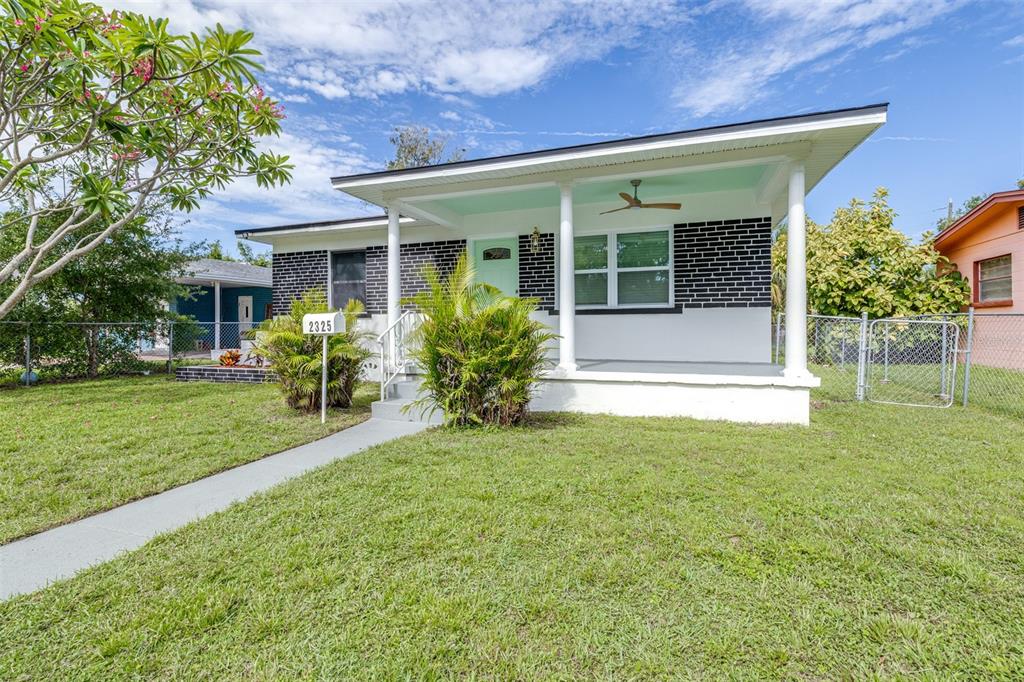 A single-story house with a black brick facade, white trim, and a covered front porch — 2325 HIGHLAND STREET S, ST PETERSBURG, FL