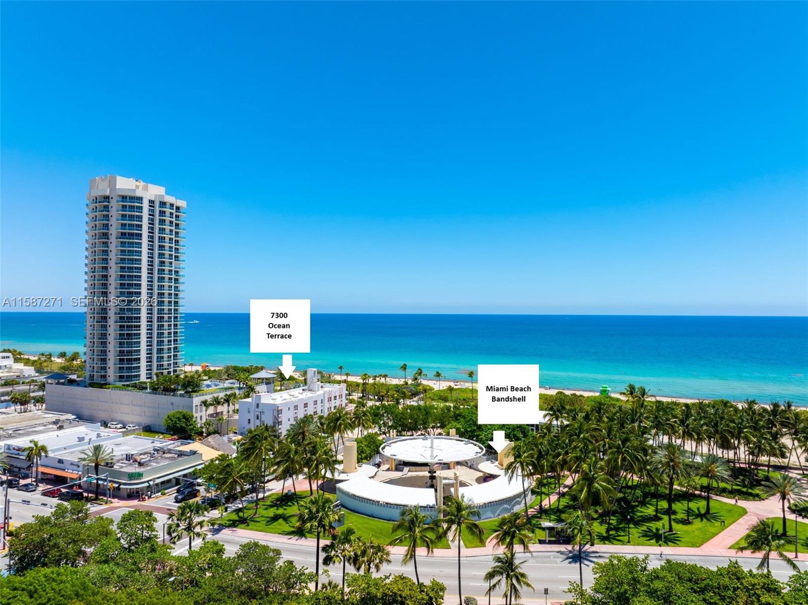 An aerial view shows a beachside park with a circular bandshell and a tall building — 7300 Ocean Ter, Miami Beach FL 33141, MIAMI BEACH, FL