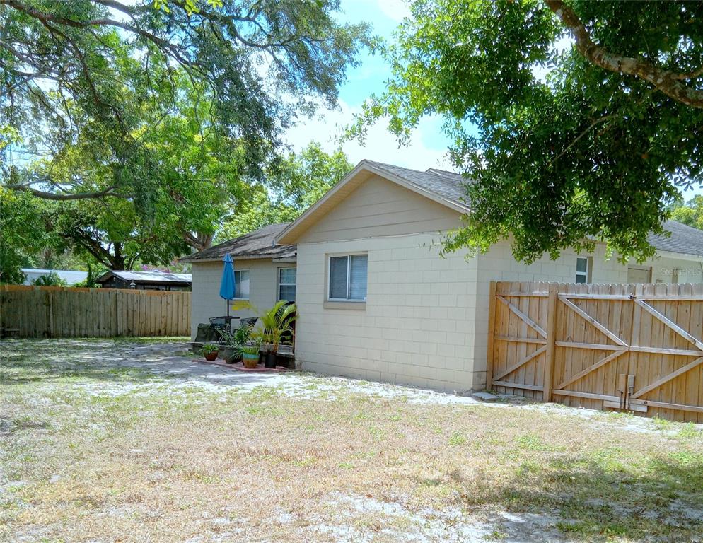 A view of the exterior of a house with a concrete block wall and fence — 7731 MARIAH COURT, ORLANDO, FL