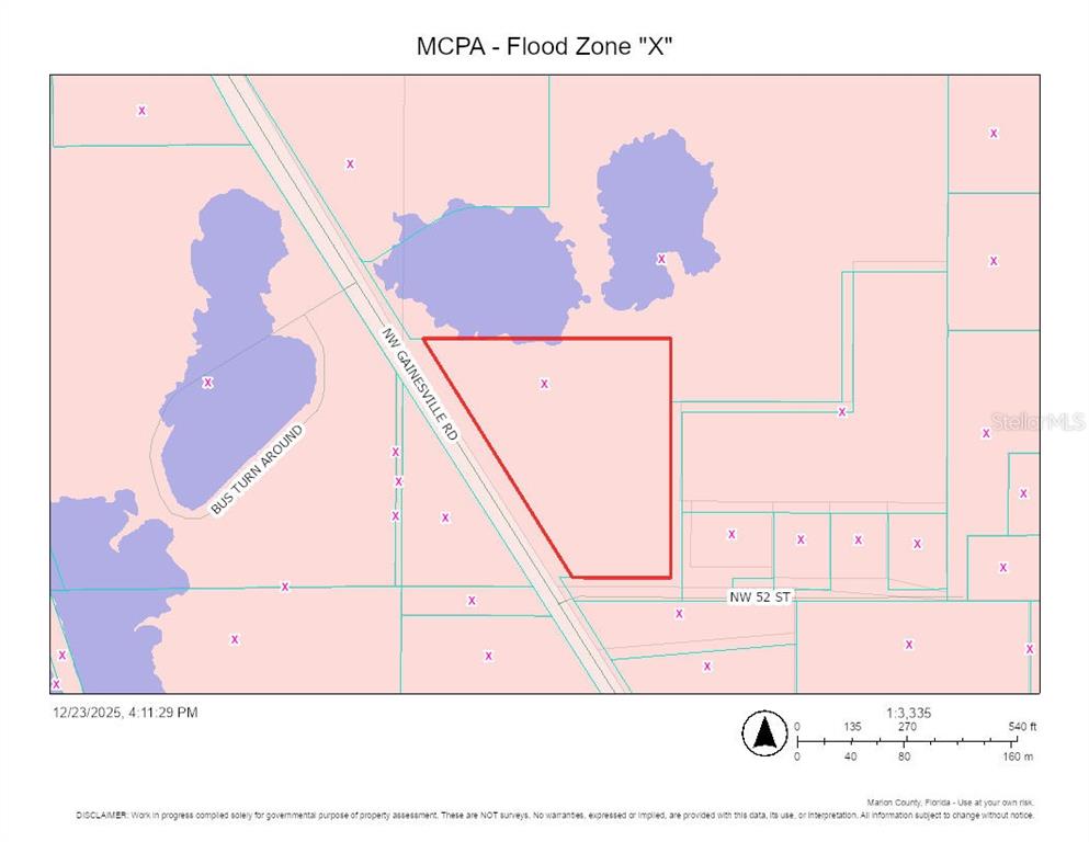 This is a map showing a property parcel highlighted in red within a flood zone — NW GAINESVILLE ROAD, OCALA, FL