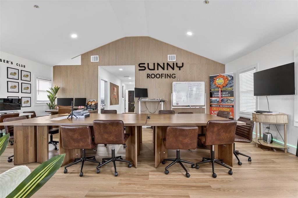 This office space features a large wooden conference table, brown chairs, and a branded wall — 1922 HILLCREST STREET, ORLANDO, FL
