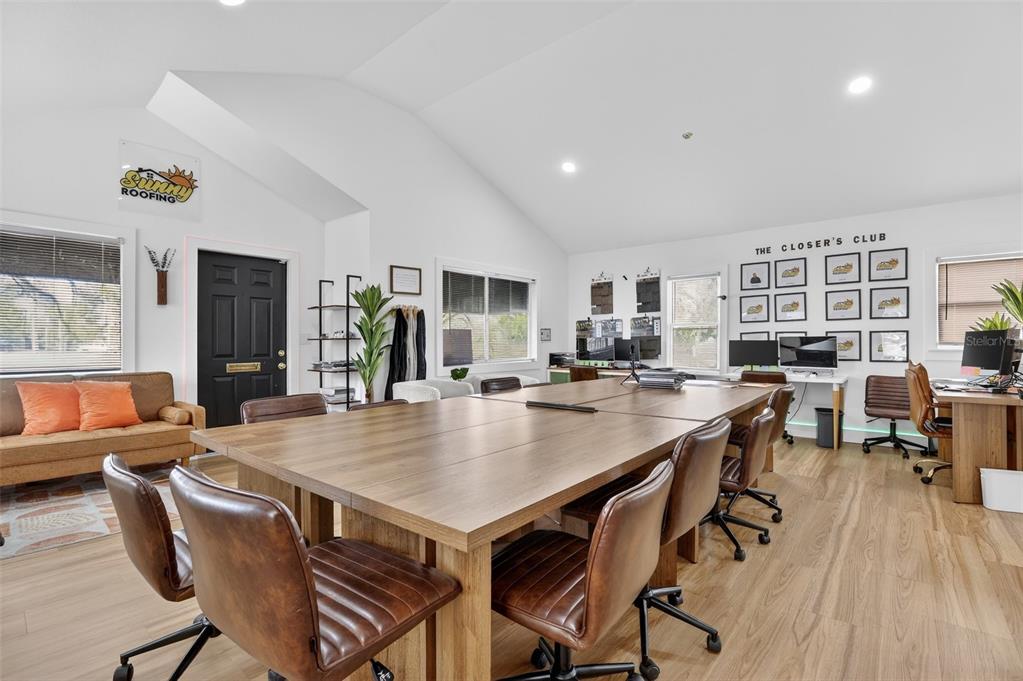 An office space features a large wooden conference table, leather chairs, and a seating area — 1922 HILLCREST STREET, ORLANDO, FL