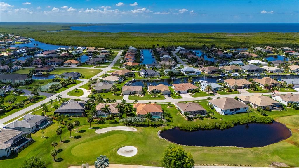 A single-story house with a tiled roof, arched entryway, and landscaped front yard — 1512 SUZI STREET, PUNTA GORDA, FL