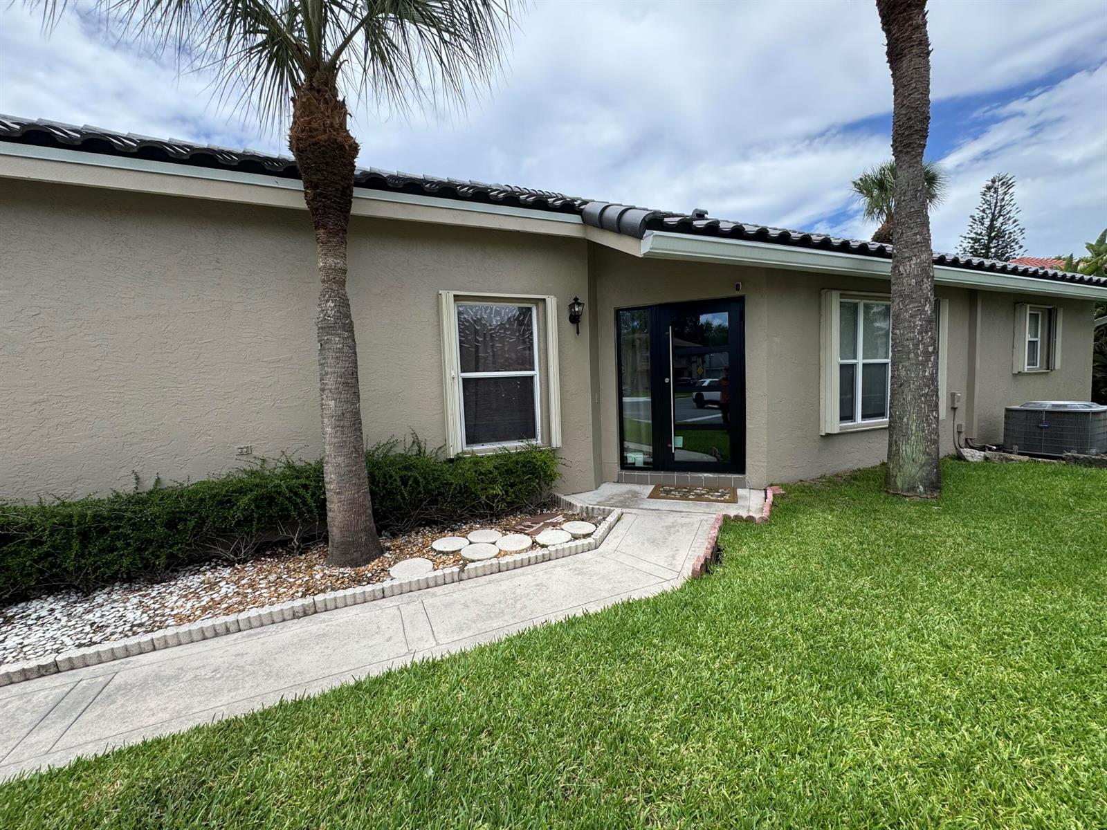 An empty room with gray walls, tile flooring, a chandelier, and vaulted ceilings — 10278 Serene Meadow Drive N, Boca Raton FL 33428, BOCA RATON, FL