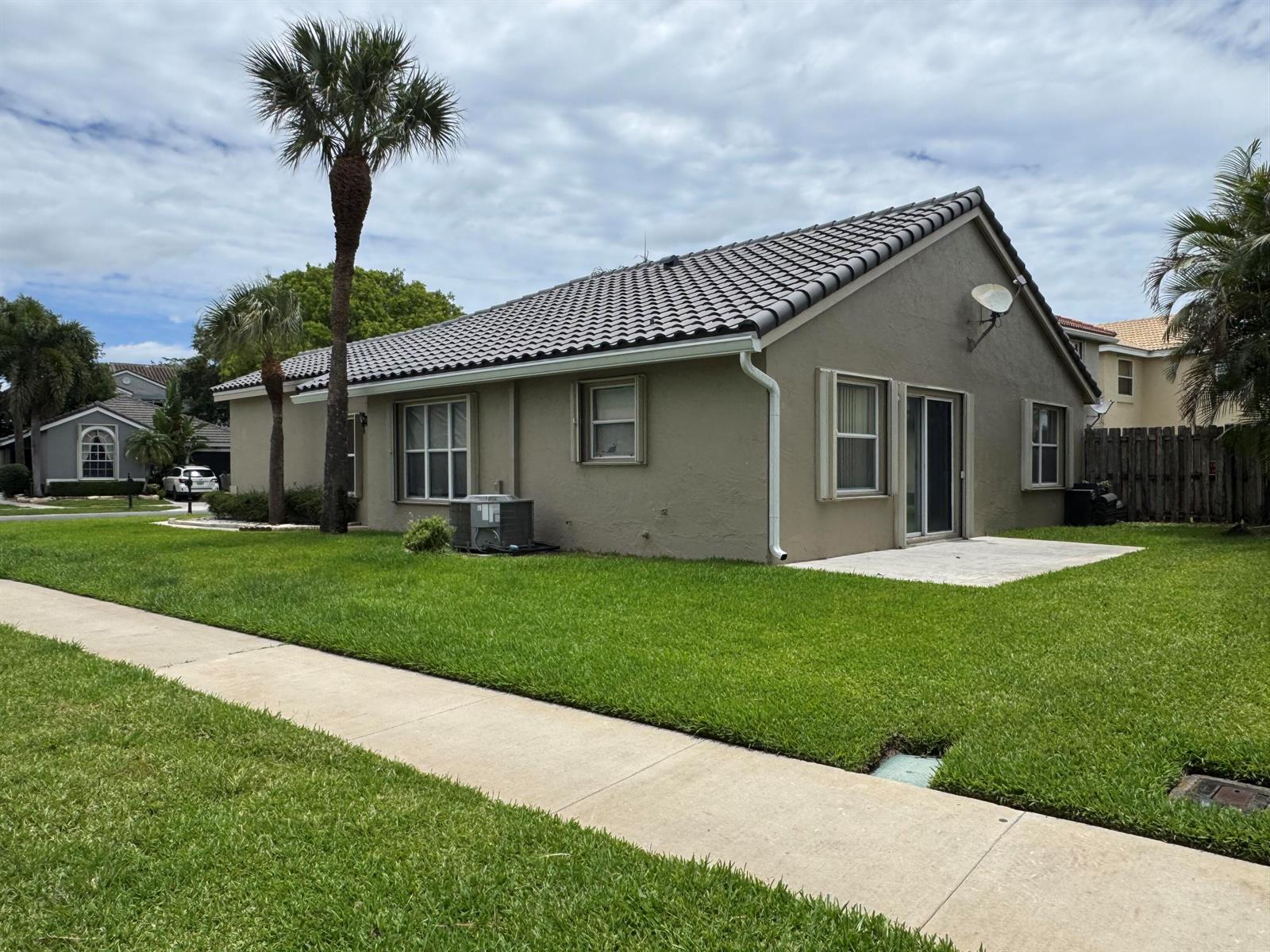 A kitchen with white cabinets, white tile floors, and stainless steel and black appliances — 10278 Serene Meadow Drive N, Boca Raton FL 33428, BOCA RATON, FL