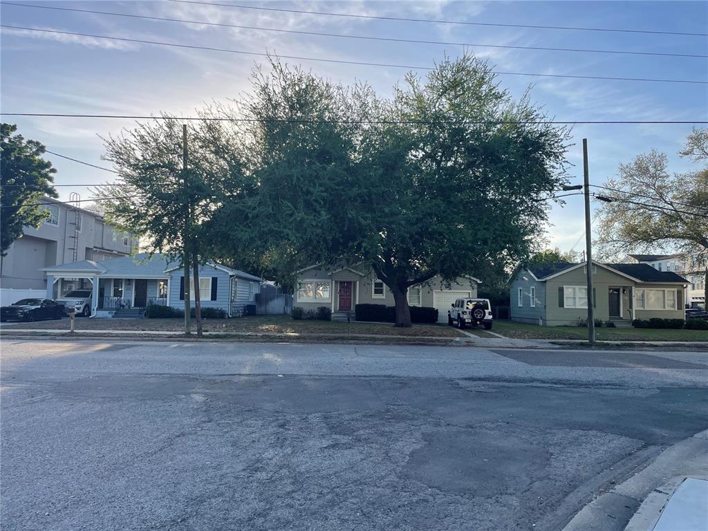 A street view shows three single-story houses with trees and parked cars in front — 301 S AUDUBON. AVENUE, TAMPA, FL