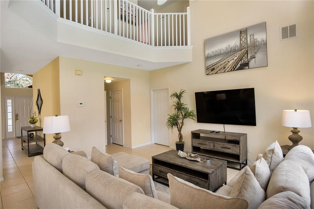 A two-story house with a tan stucco exterior and a red tile roof — 134 SEVILLA AVENUE, DAVENPORT, FL