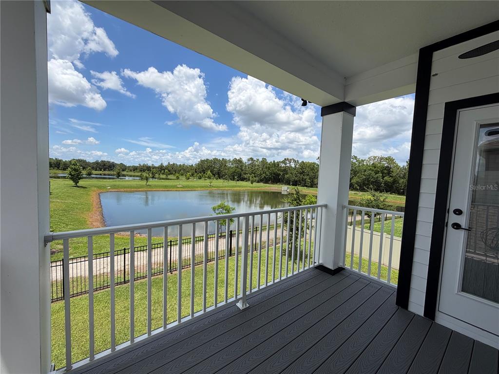 An entryway with a light blue door leads into a tiled room with two chairs — 3743 BRANDING IRON BEND, ST CLOUD, FL