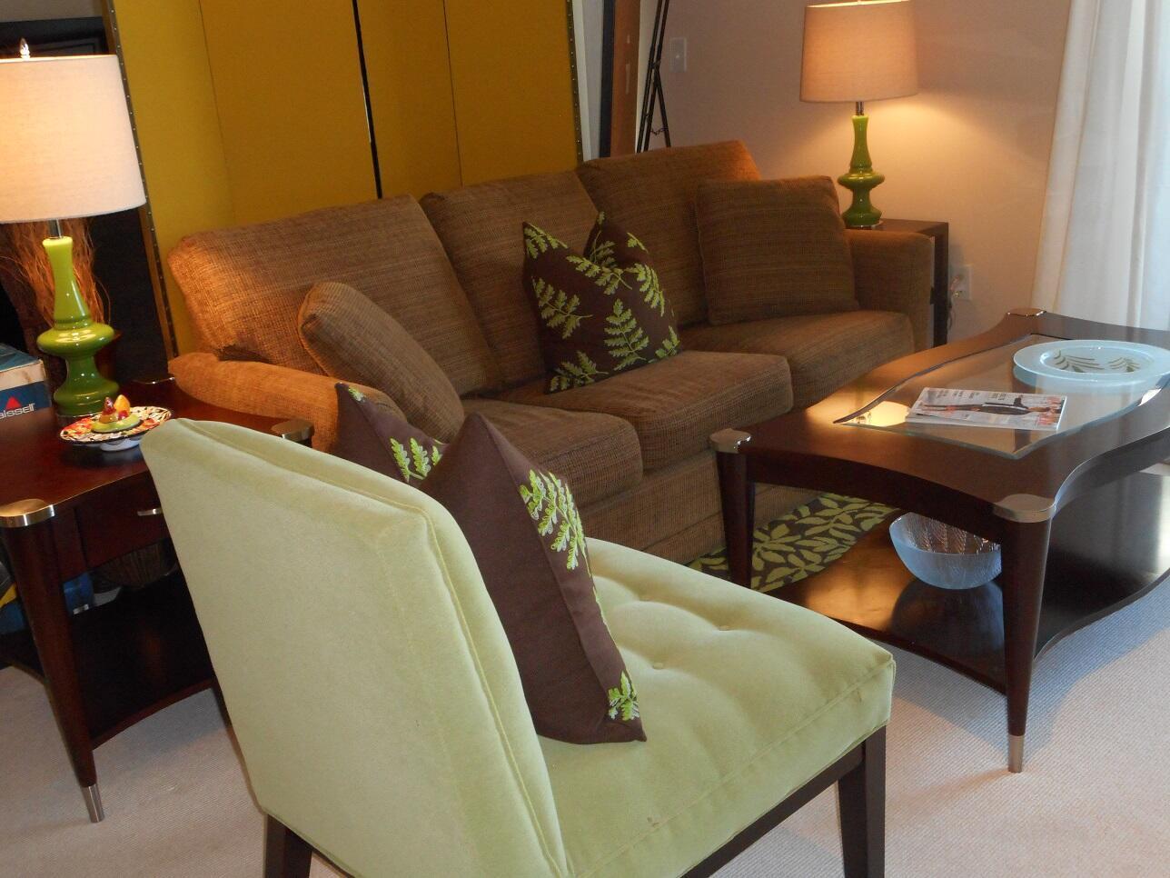 A living room features a brown sofa, a light green chair, and two matching lamps — 600 S Dixie Highway # 452, West Palm Beach FL 33401, WEST PALM BEACH, FL
