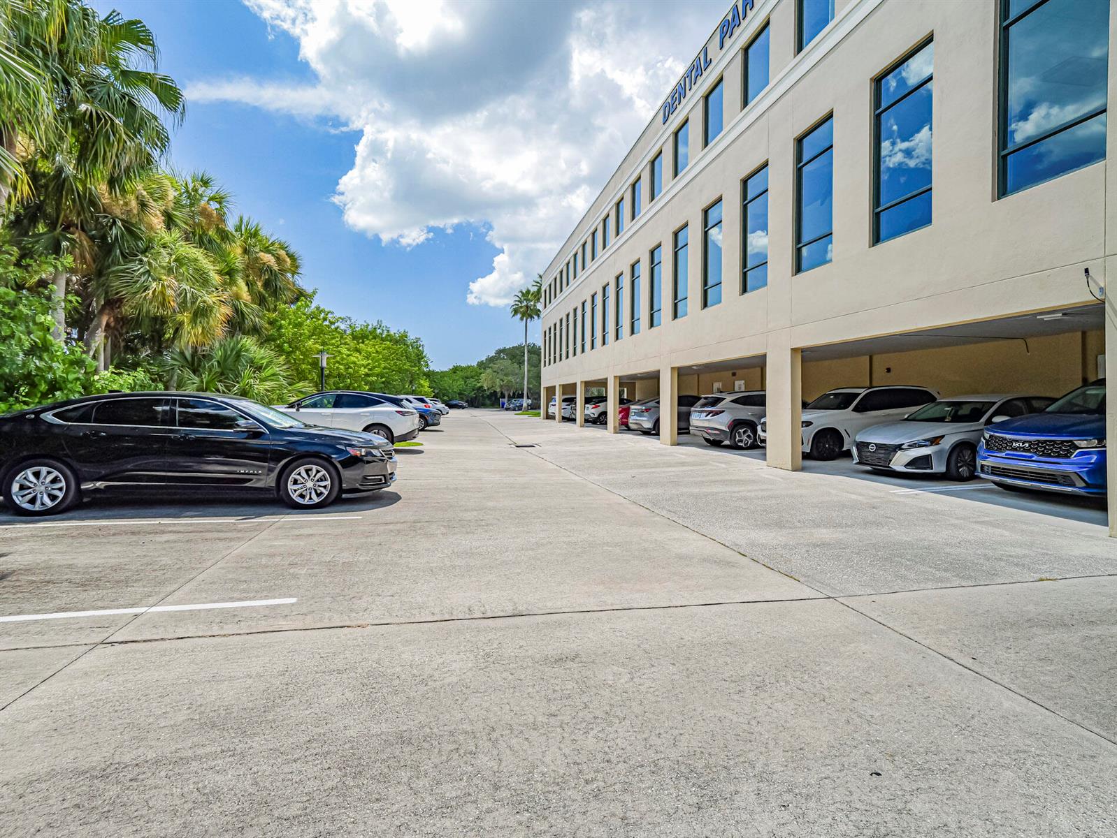 A multi-story building with covered ground-level parking and several cars parked in the lot — 3755 7th Terrace, Vero Beach FL 32960, VERO BEACH, FL