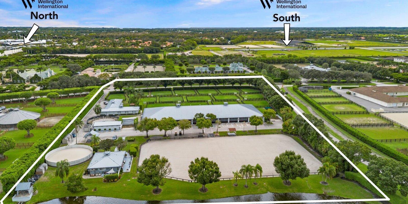 An aerial view of an equestrian property featuring a large barn, riding arena, and paddocks — 3604 Olde Hampton Drive # 1h, Wellington FL 33414, WELLINGTON, FL