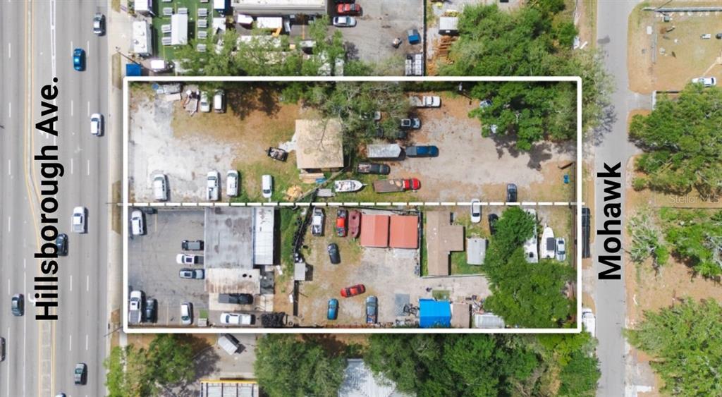 This aerial view shows a rectangular lot with buildings, parking areas, and vehicles — 6923 W HILLSBOROUGH AVENUE, TAMPA, FL