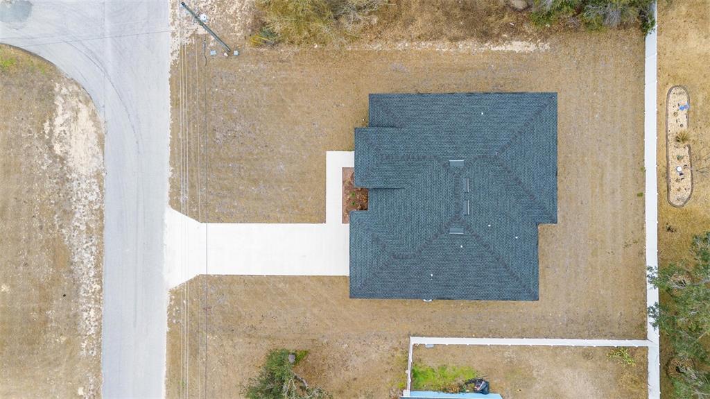 An aerial view shows a house with a dark roof on a large, grassy lot — 16367 SW 16TH COURT, OCALA, FL