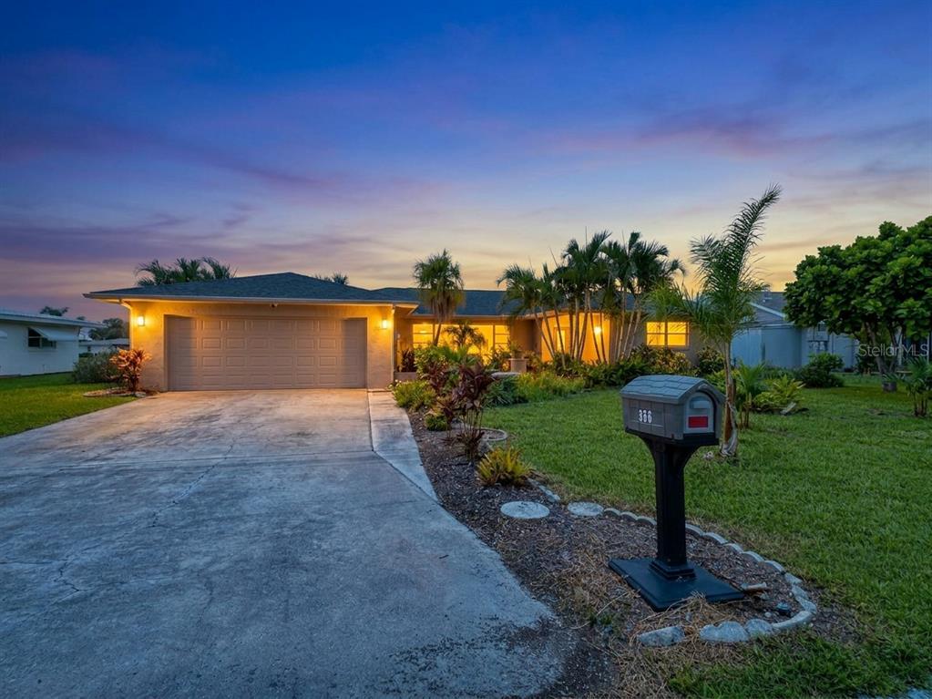 A single-story house with a concrete driveway, two-car garage, and a mailbox in the yard — 356 PEPPERTREE ROAD, VENICE, FL