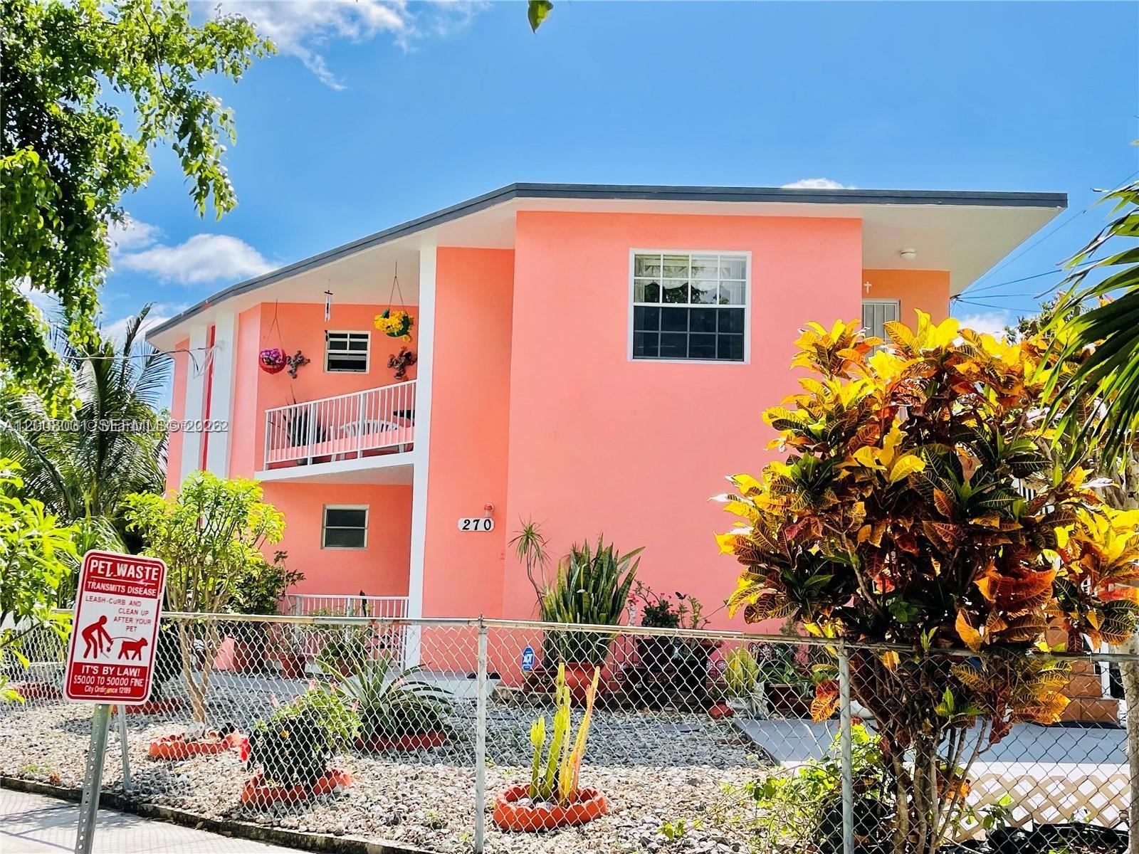 A two-story peach-colored apartment building with a chain-link fence and landscaping in the front — 270 NW 34th Ter, Miami FL 33127, MIAMI, FL