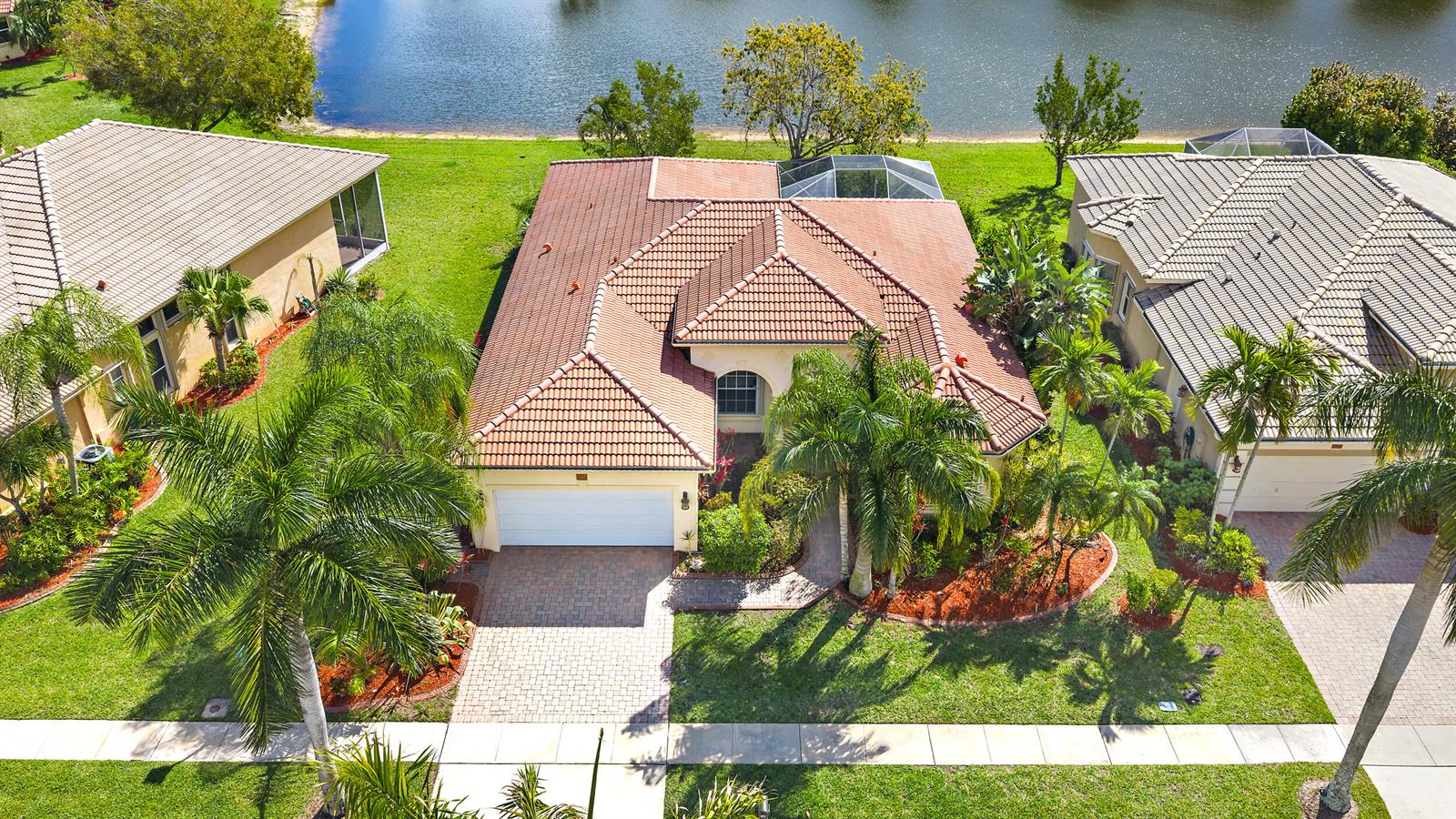 An aerial view shows a suburban house with a tiled roof, garage, and backyard pool — 9531 Lantern Bay Circle, West Palm Beach FL 33411, WEST PALM BEACH, FL
