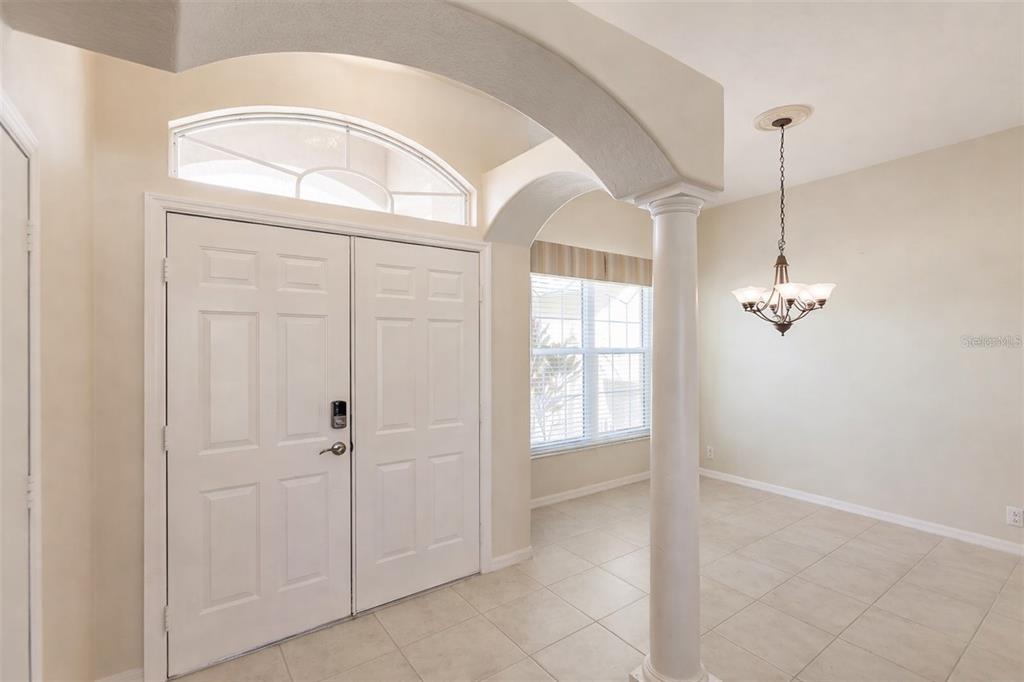 An entryway with tile floors, a white double door, and a decorative column — 2520 SILVER PALM ROAD, NORTH PORT, FL
