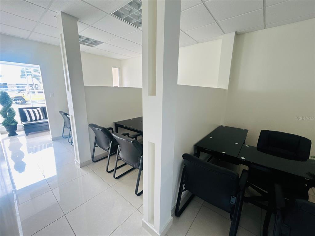 An office space features white walls, tiled floors, and several black desks with matching chairs — 1396 CALLE BONITA, PONCE, PR