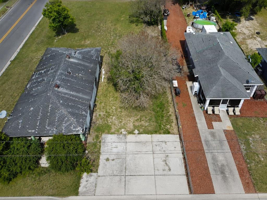 An aerial view shows two adjacent houses with a large tree between them — D STREET, LAKE WALES, FL