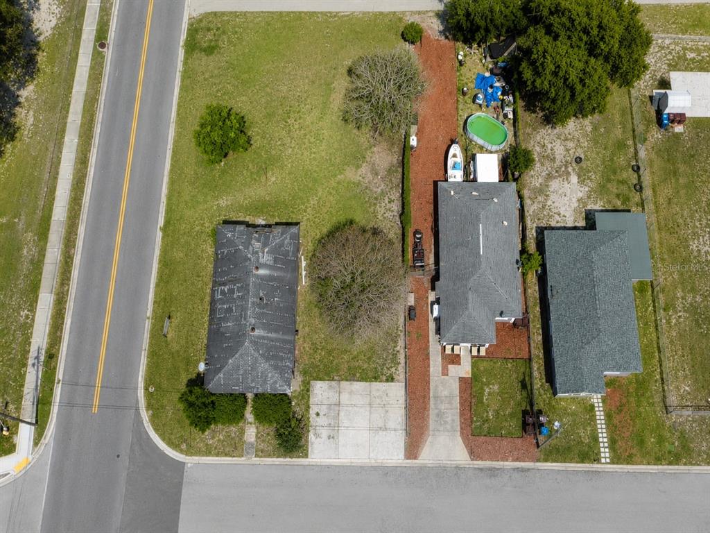An aerial view shows two houses, a driveway, a swimming pool, and a grassy yard — D STREET, LAKE WALES, FL