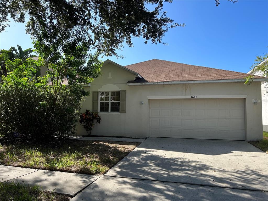 An empty room with light yellow walls, wood-look flooring, and a window with blinds — 11164 GOLDEN SILENCE DRIVE, RIVERVIEW, FL
