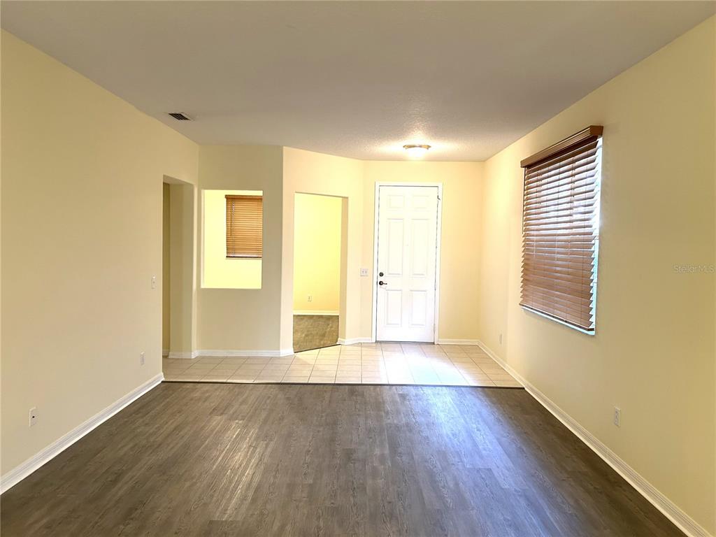 A kitchen with wood cabinets, a black refrigerator, and a breakfast bar island — 11164 GOLDEN SILENCE DRIVE, RIVERVIEW, FL