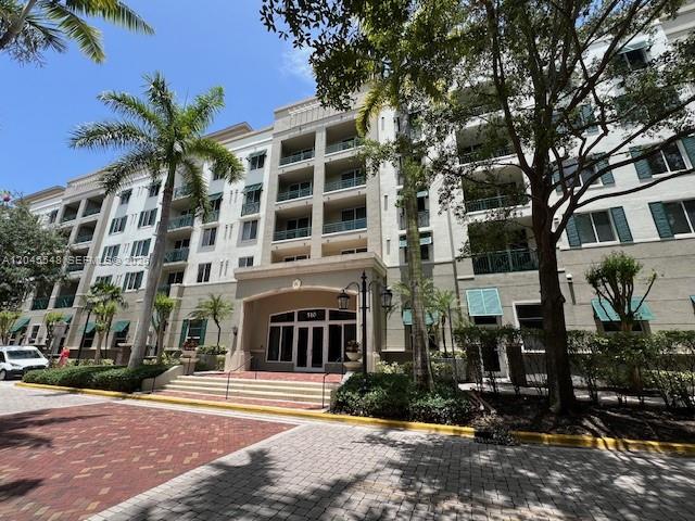 A multi-story apartment building features a beige facade, balconies, and a palm-lined entrance — 510 NW 84th Ave # 534, Plantation FL 33324, PLANTATION, FL