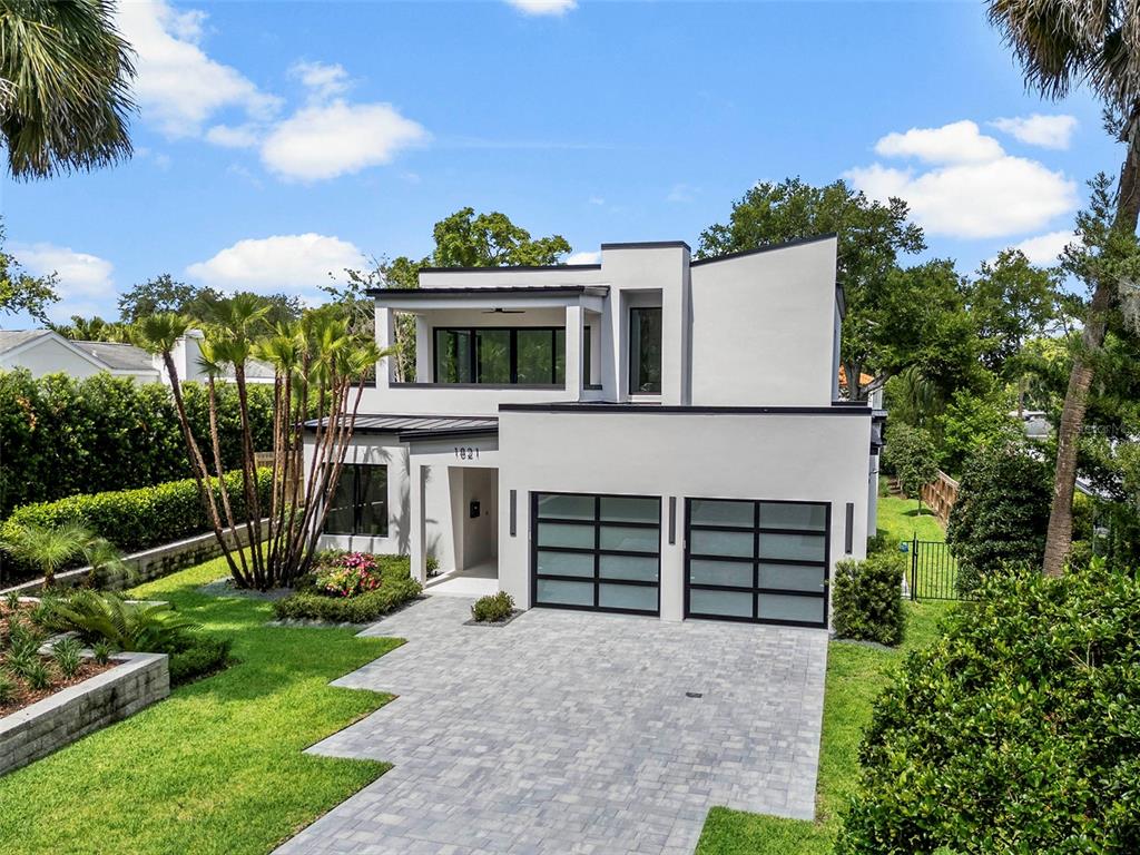 A modern two-story house with a white exterior, flat roof, and a paved driveway — 1821 ENGLEWOOD ROAD, WINTER PARK, FL